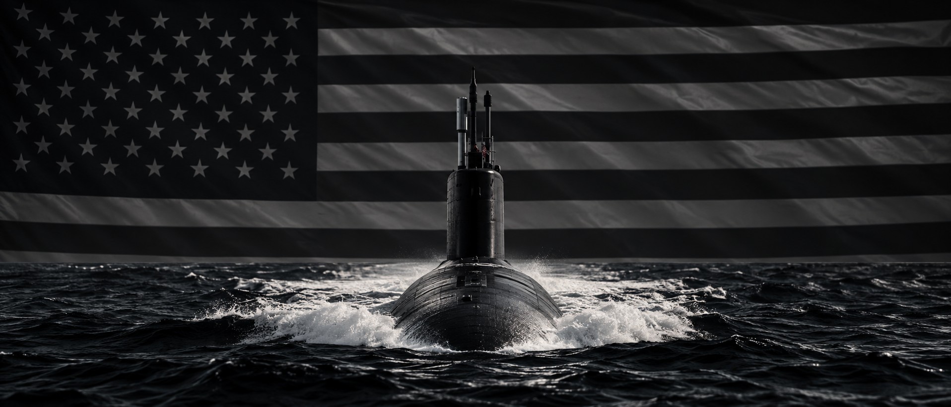 A submarine emerging head-on through dark water beneath a monochrome American flag